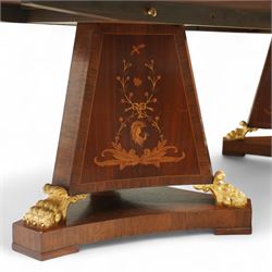 Arthur Brett & Sons - late 20th century twin pedestal dining table in the Second Empire style, the oval Amboyna burl veneered top, bordered with tulipwood crossbanding and delicate floral marquetry inlay, and rosewood crossbanded outer border within gilt gadrooned edge, over two mahogany triform pedestal bases with rosewood crossbanding and decorated with neoclassical marquetry of tied ribbons, leafy sprays, and scrolling acanthus decoration, raised on carved and gilded lion paw terminals on plinth bases, underside with maker's label