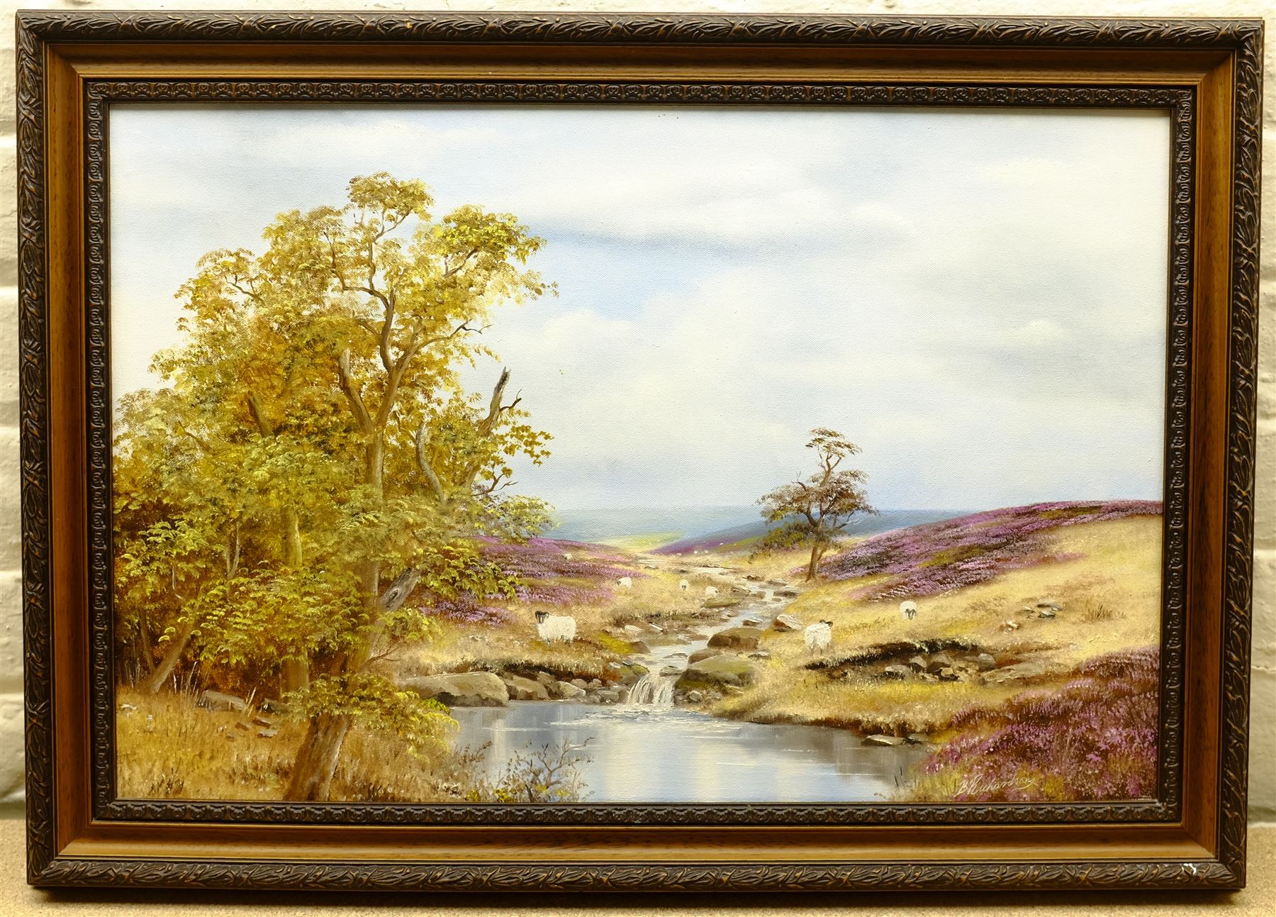 Brian Richardson (British 20th century): Sheep Grazing on the North York Moors, oil on canvas signed, artist's Helmsley address label verso 40cm x 60cm