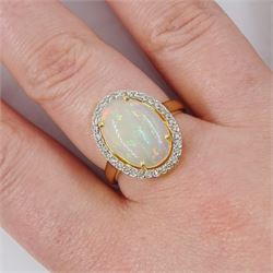 14ct gold opal and diamond cluster ring, single cabochon cut opal of approx 2.80 carat, with round brilliant cut diamond surround, stamped, total diamond weight approx 0.35 carat