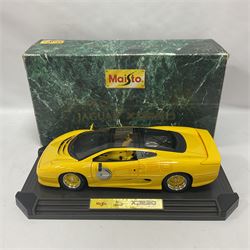 Two Maisto 1:12 scale Jaguar XJ220 ‘Racing’ cars in yellow, both on plinths in original boxes 