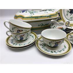 20th century Hermes Paris porcelain dinner and tea service for eight place settings, decorated in the Toucans pattern, comprising dinner plates, salad plates, dessert plates, dishes, tureen and cover, oval platter, shallow bowl, high sided bowl, sauce boat and stand, teapot, teacups and saucers, twin handled sucrier and cover, and milk jug, with green printed marks beneath, with a number of Hermes dust bags