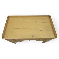 Pine country writing desk, rustic cream paint finish, galleried top over a central drawer flanked by two drawers, tapered square supports
