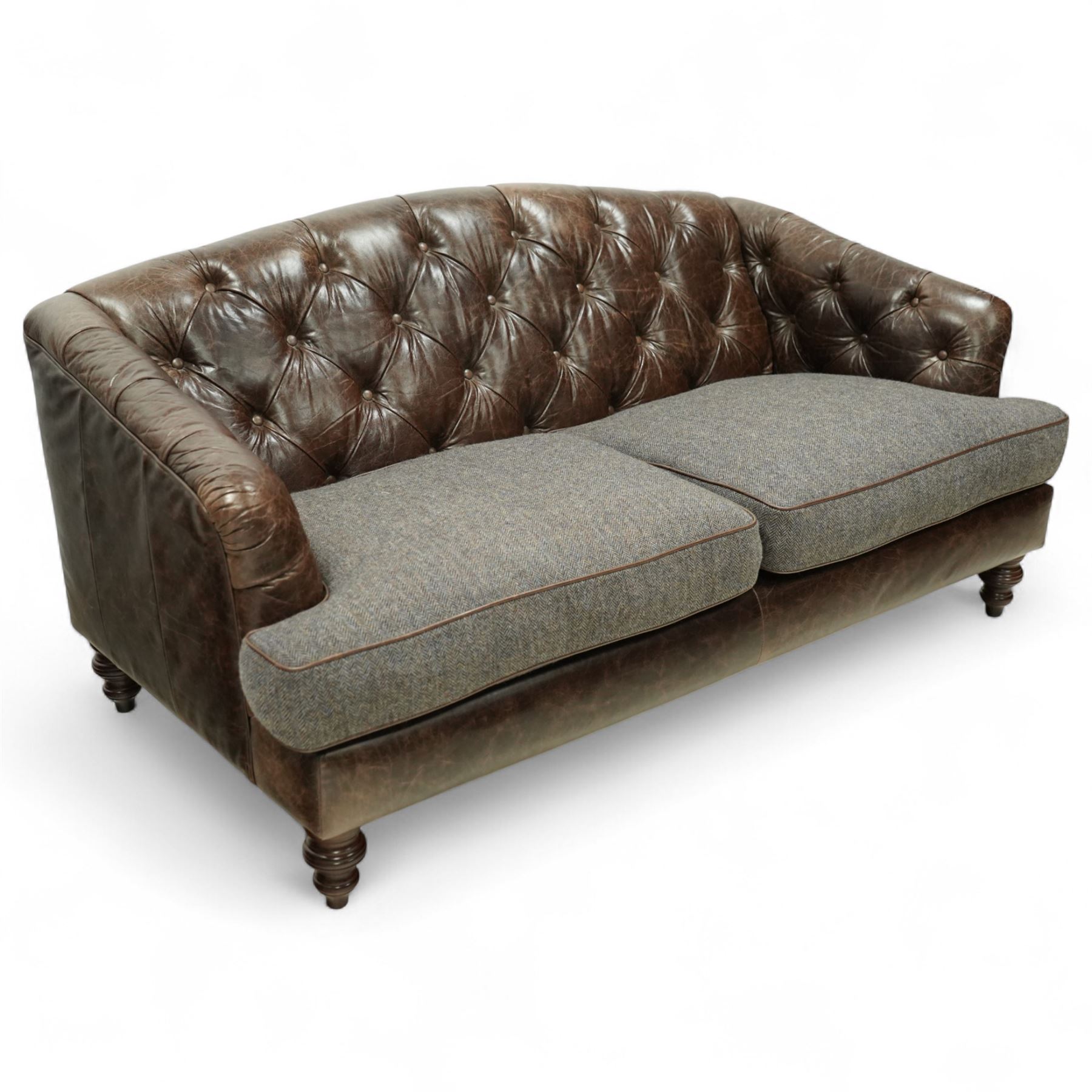 Tetrad - Harris Tweed and leather upholstered Chesterfield sofa, curved back and arms  with deep buttoned brown leather upholstery above loose herringbone tweed seat cushions with brown leather piping, raised on turned wooden feet 
