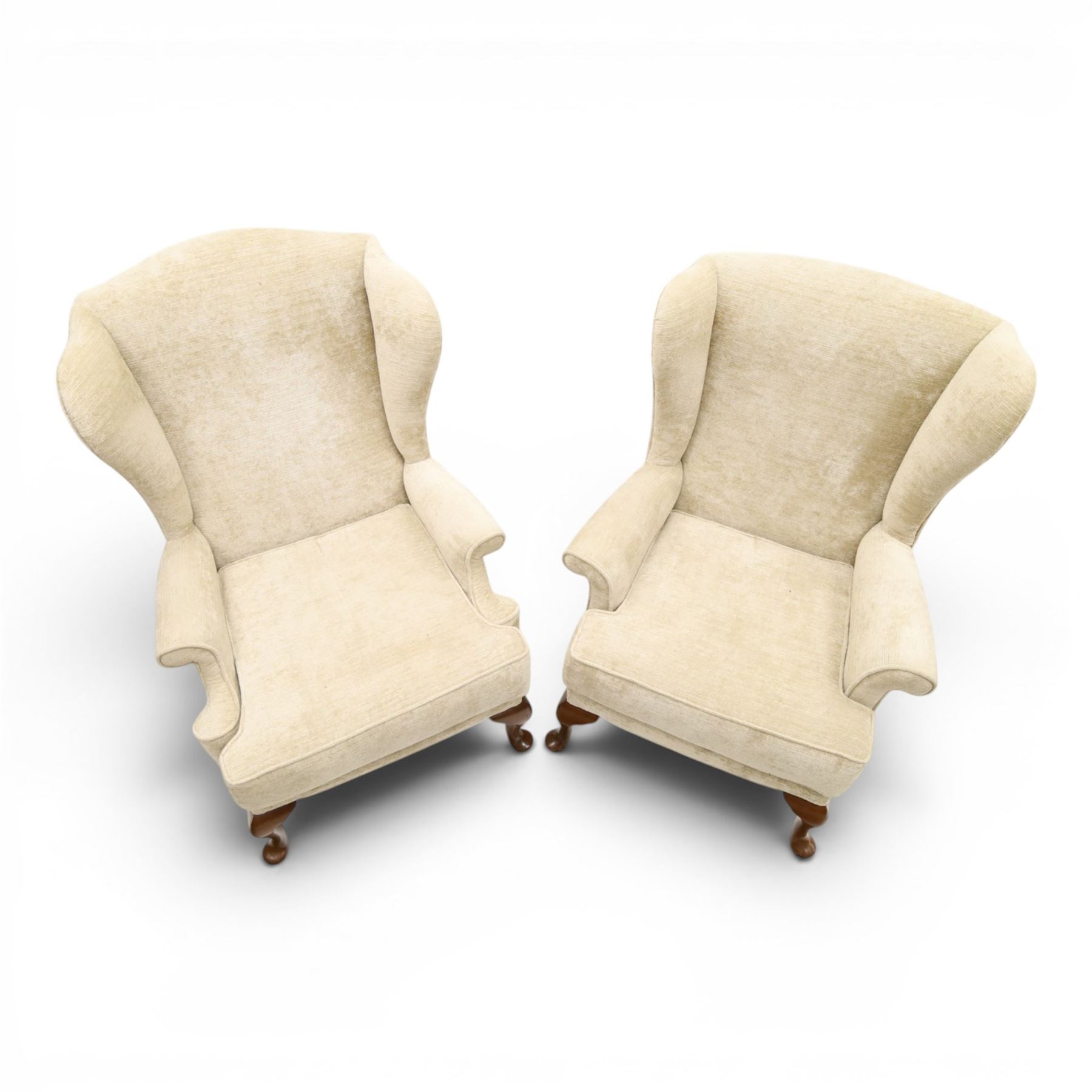 Parker Knoll - 'Hartley' lounge suite, comprising three wingback armchairs and two-seat settee, upholstered in cream fabric, shaped wing backs with scroll-over arms and loose seat cushions, on cabriole supports with pad feet wingbacks and settee

Armchairs: H 96cm, D 83cm, W 75cm