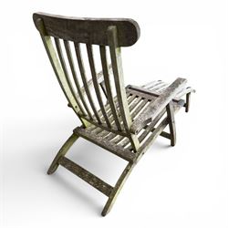 Pair of teak reclining garden steamer armchairs, each with an adjustable slatted back, curved slatted seat and footstool