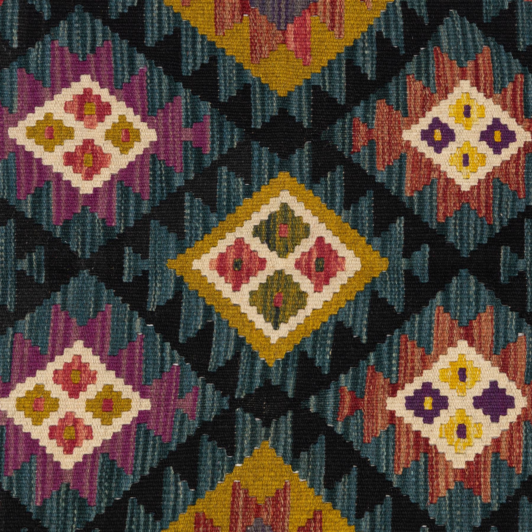 Chobi flatweave kilim runner with a repeating nested diamond medallion design in live green, rust, teal, purple, and ivory, framed by  a multicoloured geometric border
