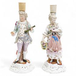 Pair of late 19th century German porcelain figural candlesticks, the male figure holding a...