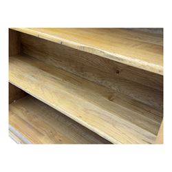 Contemporary French provincial design oak open bookcase, with projecting moulded cornice above a boarded back, fitted with four adjustable shelves, on bracketed plinth base