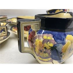 Early 20th century Art Deco Royal Doulton Pansies pattern octagonal teawares, comprising three larger teacups and saucers, three smaller teacups and saucers, open sucrier, two jugs, slop bowl, six side plates, two larger plates, two small circular dishes and one long twin handled rectangular dish, all with printed marks beneath, Rd No 597783, pattern no D4049