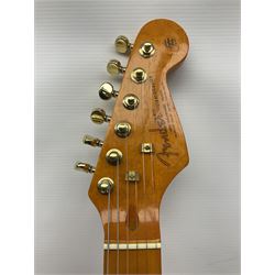 Copy of a Fender Stratocaster electric guitar in black with Wilkinson bridge, lock-in tuners, synchronised tremolo and various patent numbers; L99cm; in hard carrying case with strap and digital tuner