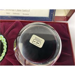 Set of four Caithness paperweights titled Four Seasons, in presentation box with certificate, designed by Colin Terris and made by William Mason, each internally decorated with a seasonal flower within a millefiori cane work garland, numbered 128 of 500