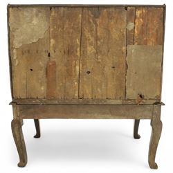 Early 18th century George I oak bureau on original stand, the fall front enclosing an arrangement of correspondence drawers and pigeonholes over central well, fitted with single long drawer below, the shaped apron over cabriole supports with pad feet