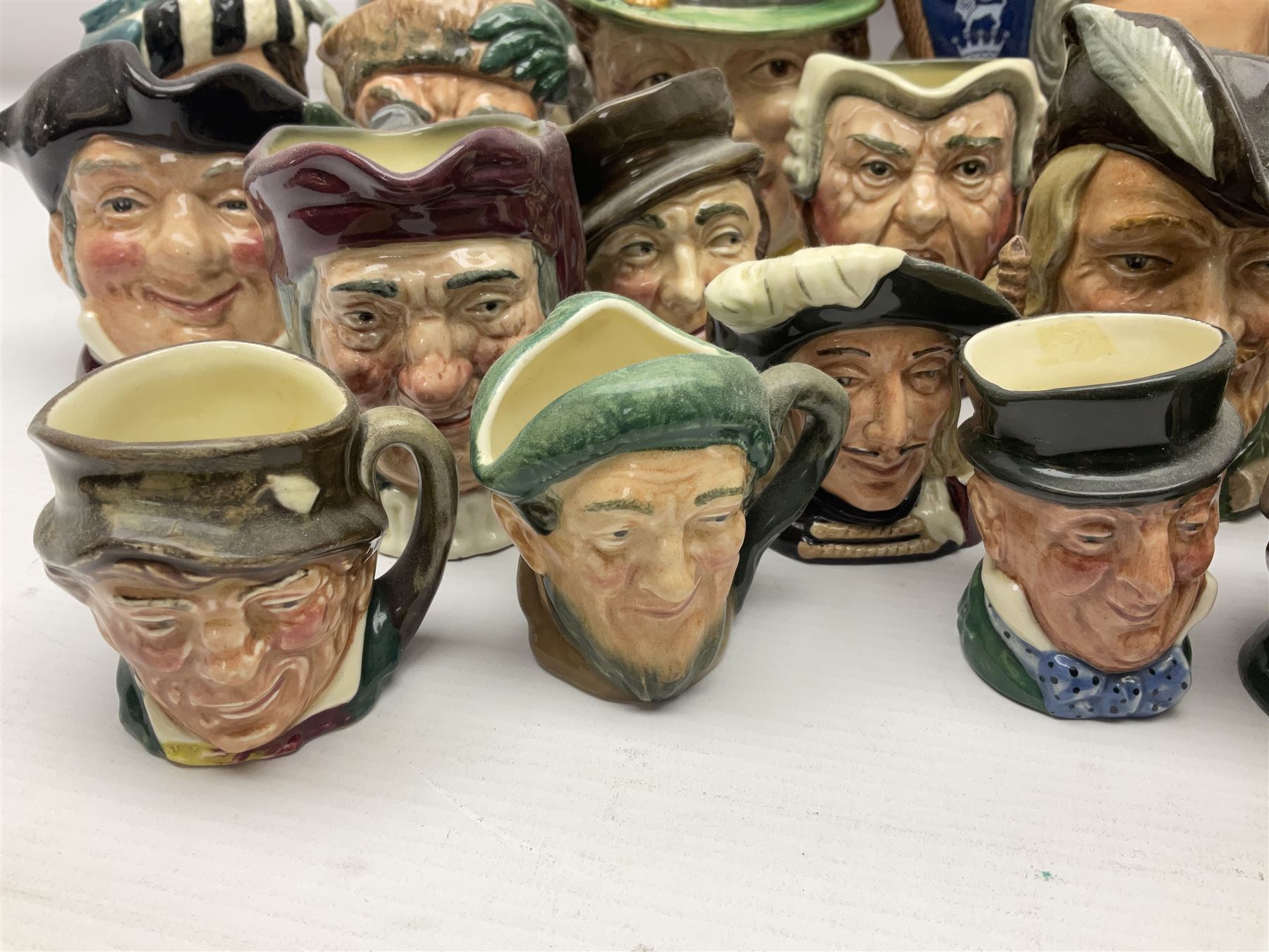 Collection of Royal Doulton and Beswick character jugs of various sizes, including North American Indian D6611, The Falconer D6533,  Tony Weller 281, Sairey Gamp 371 etc