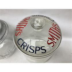 Early 20th century Meredith & Drew shop advertising glass biscuit barrel, the body of tapering form with etched lettering with original aluminium lift off lid, together with a Smith's Crisps glass jar and cover with red and dark blue letterin, tallest H25cm (2)