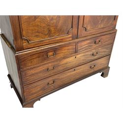 George III mahogany linen press, projecting cornice over two figured doors enclosing five linen slides, the lower section fitted with two short and two long drawers, on bracket feet