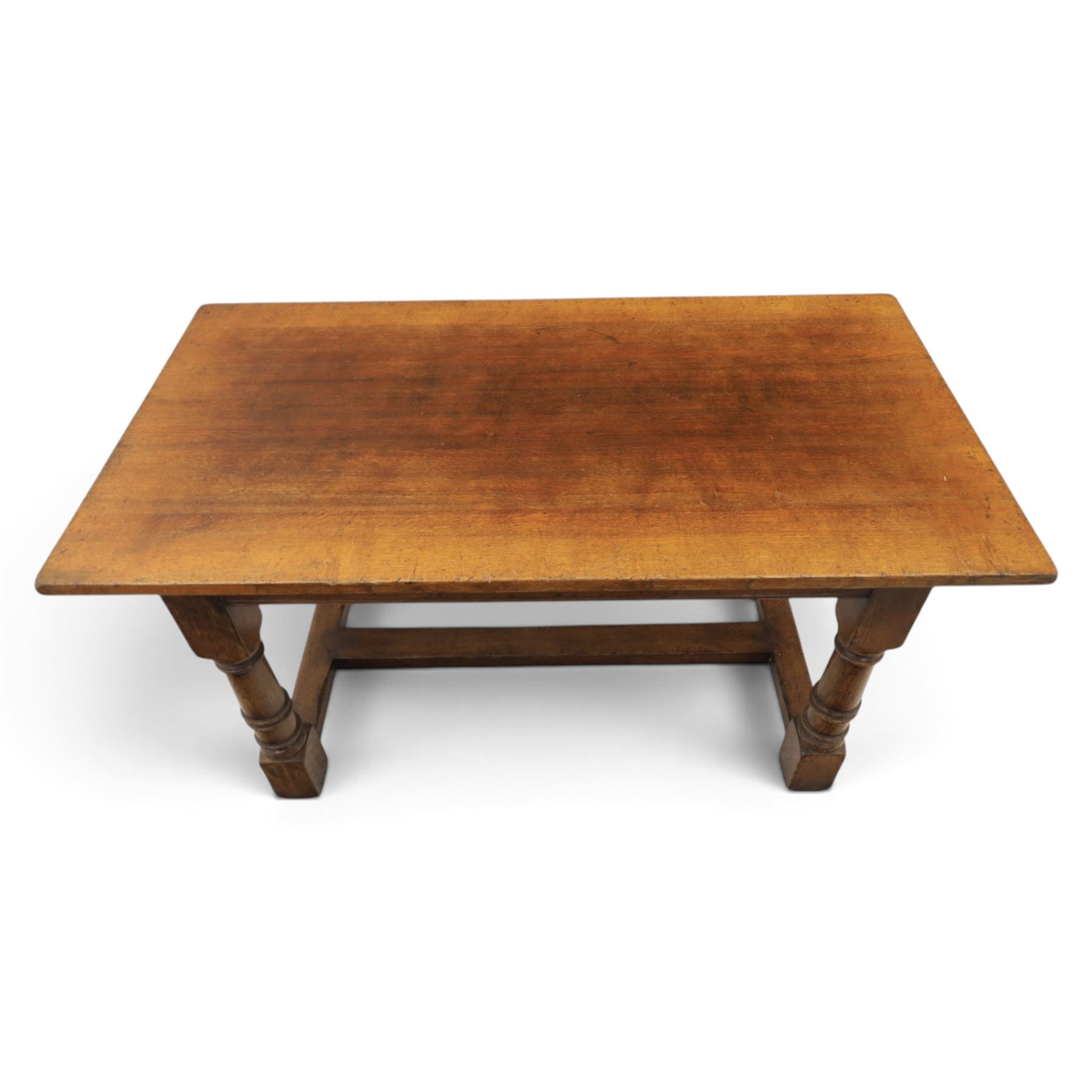Titchmarsh & Goodwin style solid oak refectory table, rectangular top raised on block and turned supports united by a full length undertier