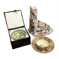 Oriental ceramics comprising a figure of a sea lion decorated with floral pattern with character mark beneath, bowl in fabric box, and cup and saucer