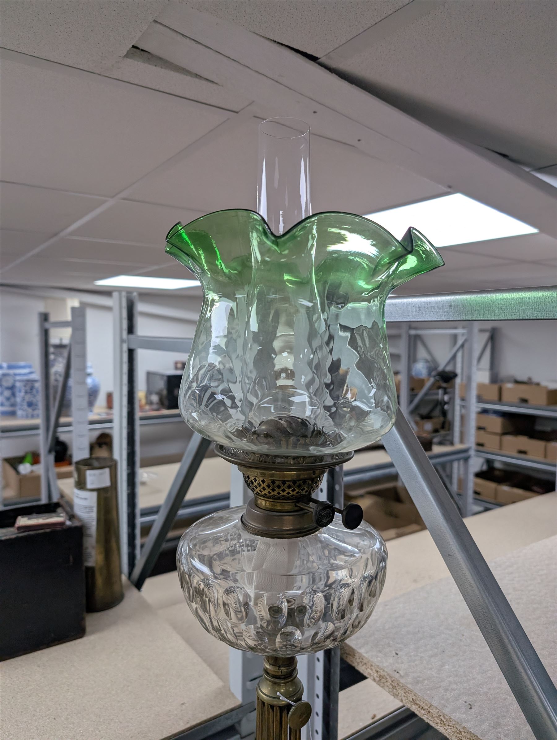 Oil lamp with frilled green glass shade, glass reservoir, upon upon corinthian column with stepped circular base, H74cm