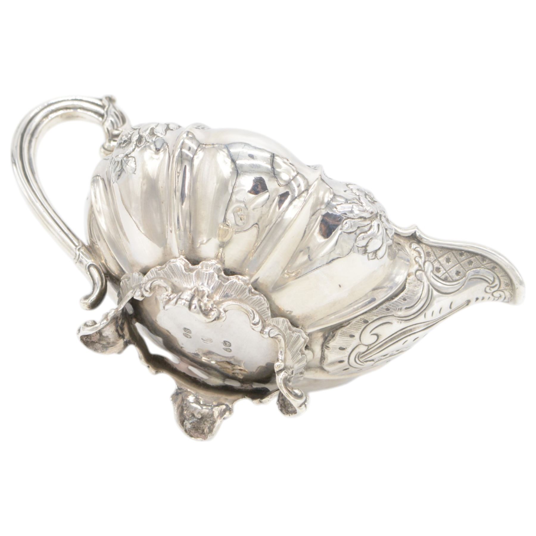 William IV silver twin handled sucrier and milk jug, each of circular bellied form, embossed with floral decoration, upon four pad scroll feet, hallmarked London 1831, maker's marks CE, including handles H10cm