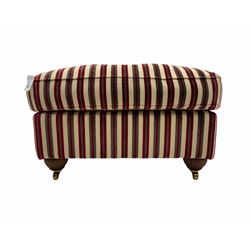 Rectangular footstool upholstered in beige and red striped fabric, mahogany bun feet with brass castors
