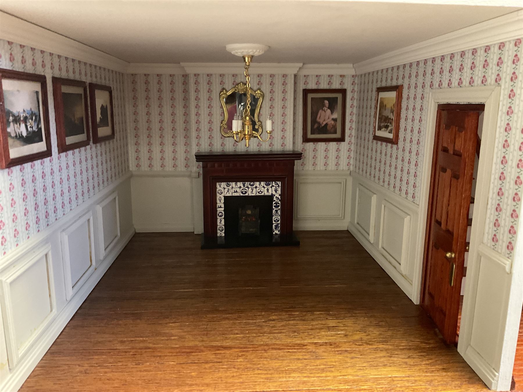 'The Hollies' - good quality sectional wooden doll's house in the form of a Georgian style four-storey bay windowed town house with simulated brick front elevation, rendered sides, off-set corner stonework, faux slate-hung top floor with flat roof and chimney stack, working sash windows, iron railings around front basement courtyard with hinged front elevation to two rooms with  spiral staircase, side hinged central section approached by external steps with iron balustrades to the sides leading to a front door, entrance hall with stairs to landing and two rooms on two floors with dado panelling and fire-surrounds, the top floor with top hung front elevation revealing stairs to a landing and bedroom; wired for electricity L51cm D65cm H107cm including chimney; together with a good quantity of quality wooden furniture and accessories including piano, dressers, bookcase and books, rugs, double half-tester bed, metalware, pictures etc