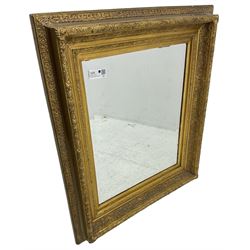 Victorian design gilt wall mirror, the frame decorated with moulded gold foliate patterns, with rectangular bevelled plate