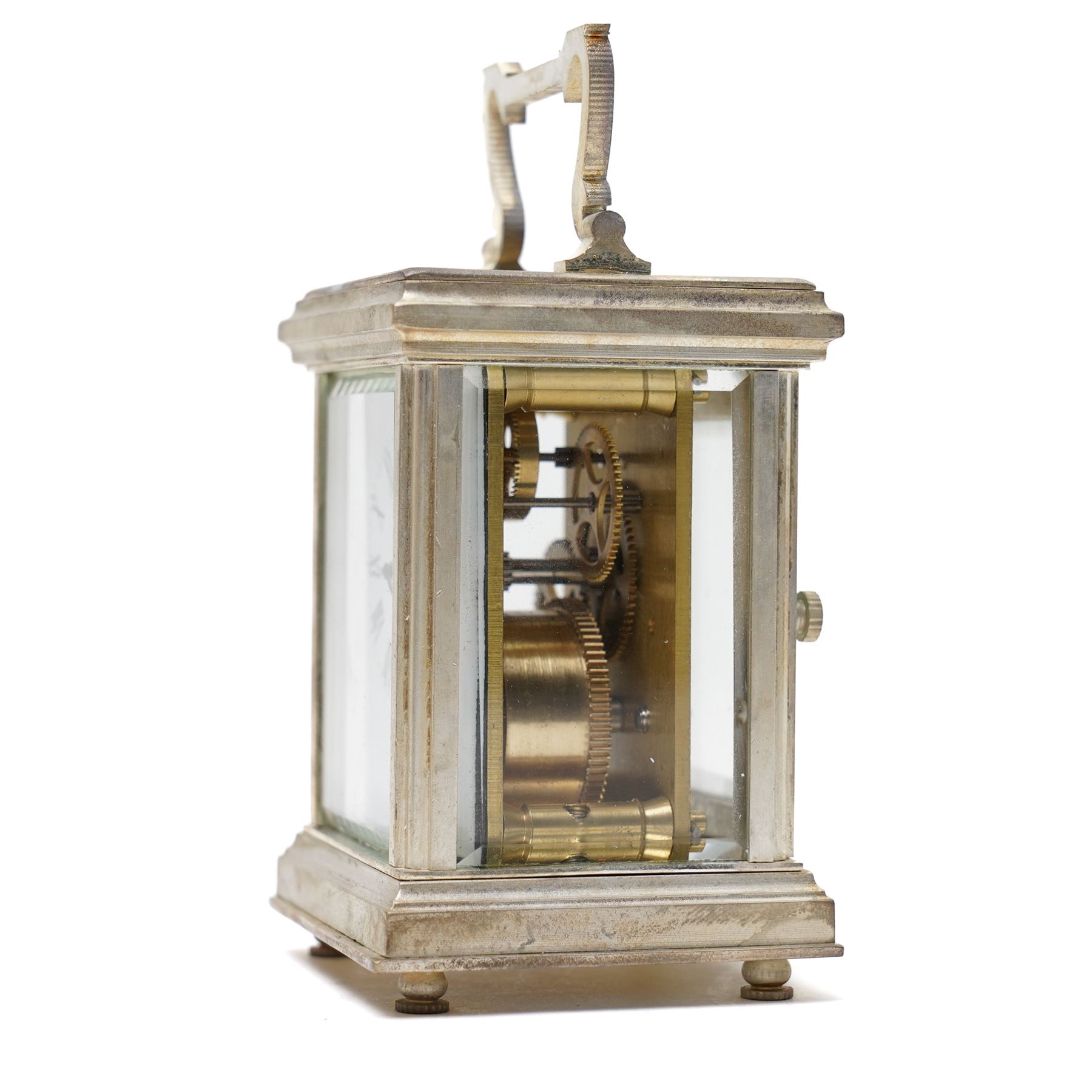 20th century- Silver plated miniature carriage clock in an anglaise case with an enamel dial, Roman numerals, minute track and pieced steel hands, with an oval viewing glass to the lever platform escapement.