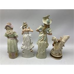 Late 19th century continental spill vase as a young girl standing beside an open tree trunk H21cm; and three German bisque figures (4)
