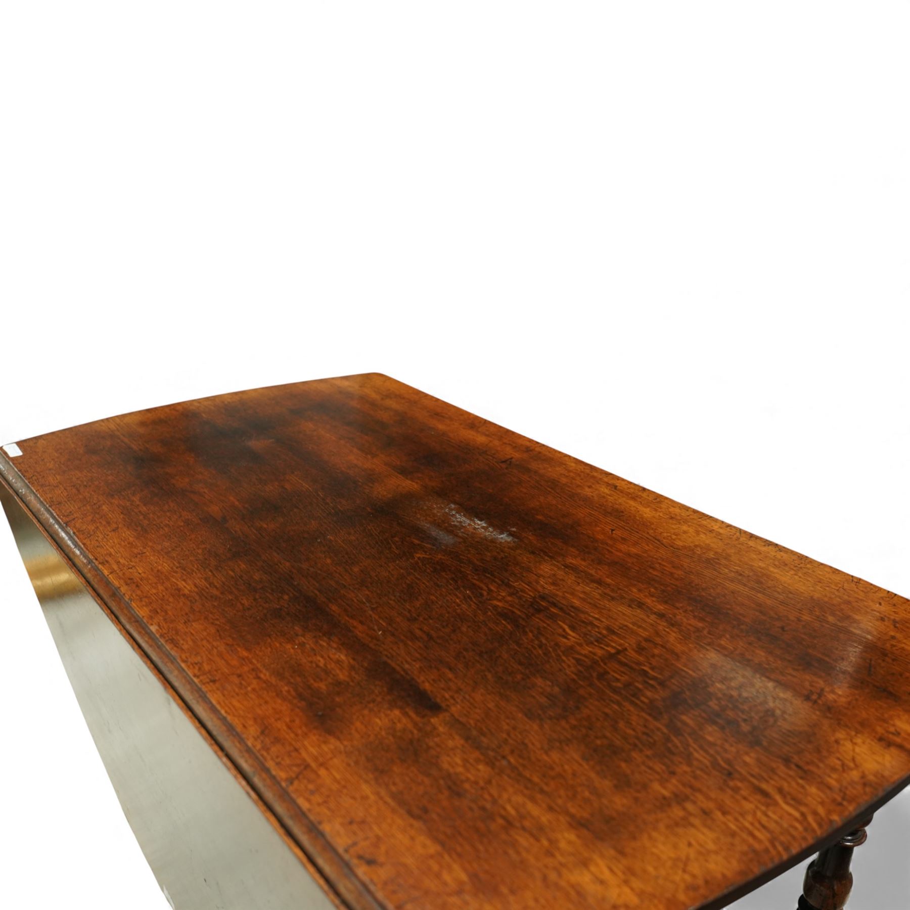 Large 18th century design oak drop-leaf dining table, oval top with twin hinged drop leaves, drawers to either end, raised on turned supports united by an H-stretcher base