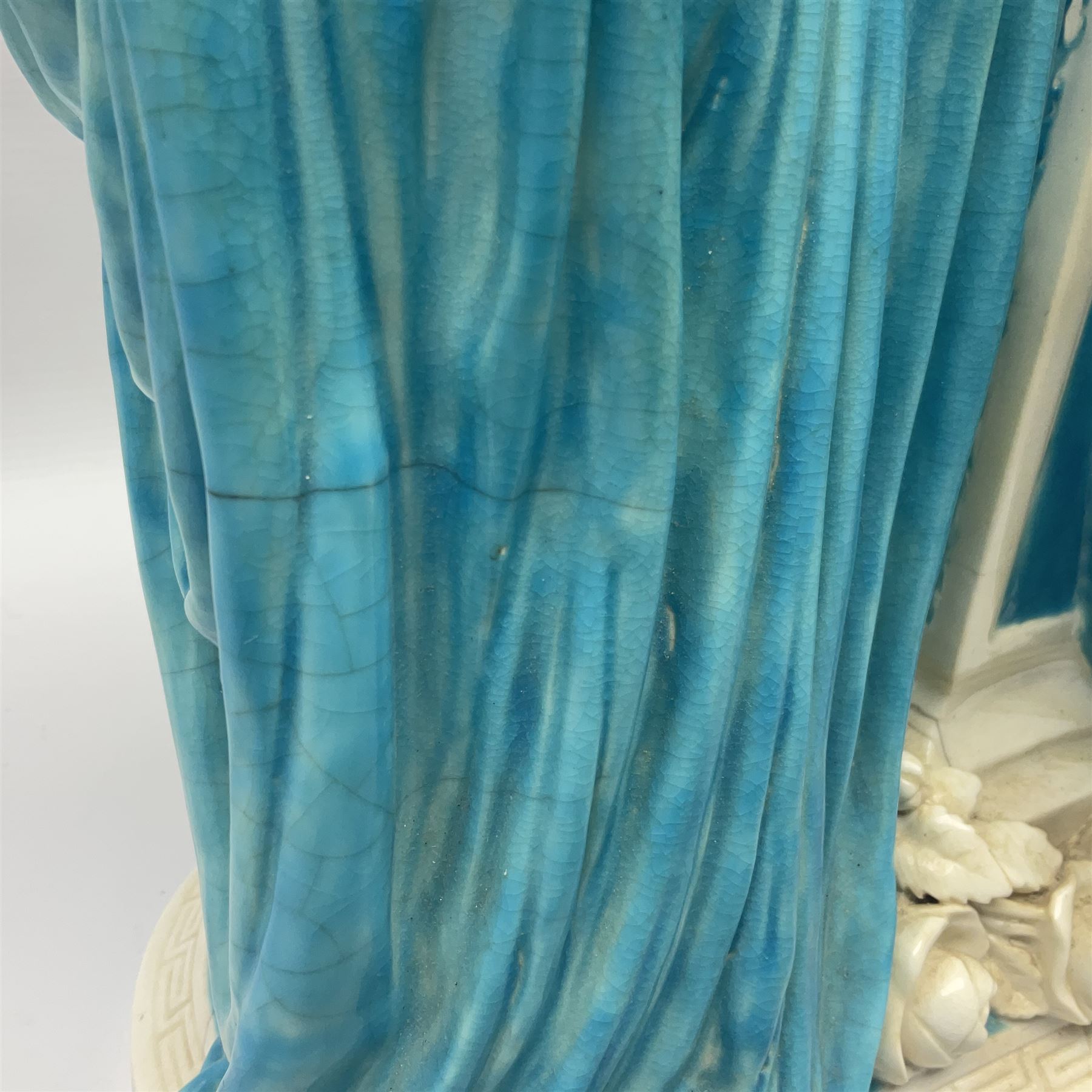 Rare 19th century Minton turquoise glaze majolica 'The Reader' flower holder, after Albert Carrier-Belleuse, modeled as a maiden in classical drapery reading whilst leaning against the pillar back of the helmet shaped cistern detailed with a caryatid and floral swags, the whole upon an oval plinth with Greek key border, with impressed marks beneath, H44cm