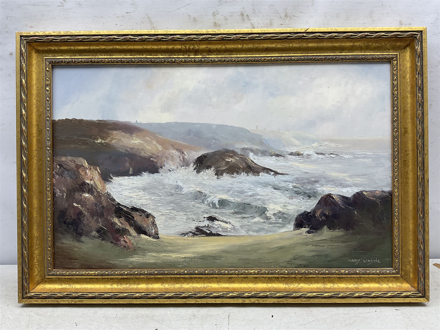 Mary Wastie (Cornish 1935-): Rocky Seascape near Pendeen, oil on canvas signed 39cm x 65cm 