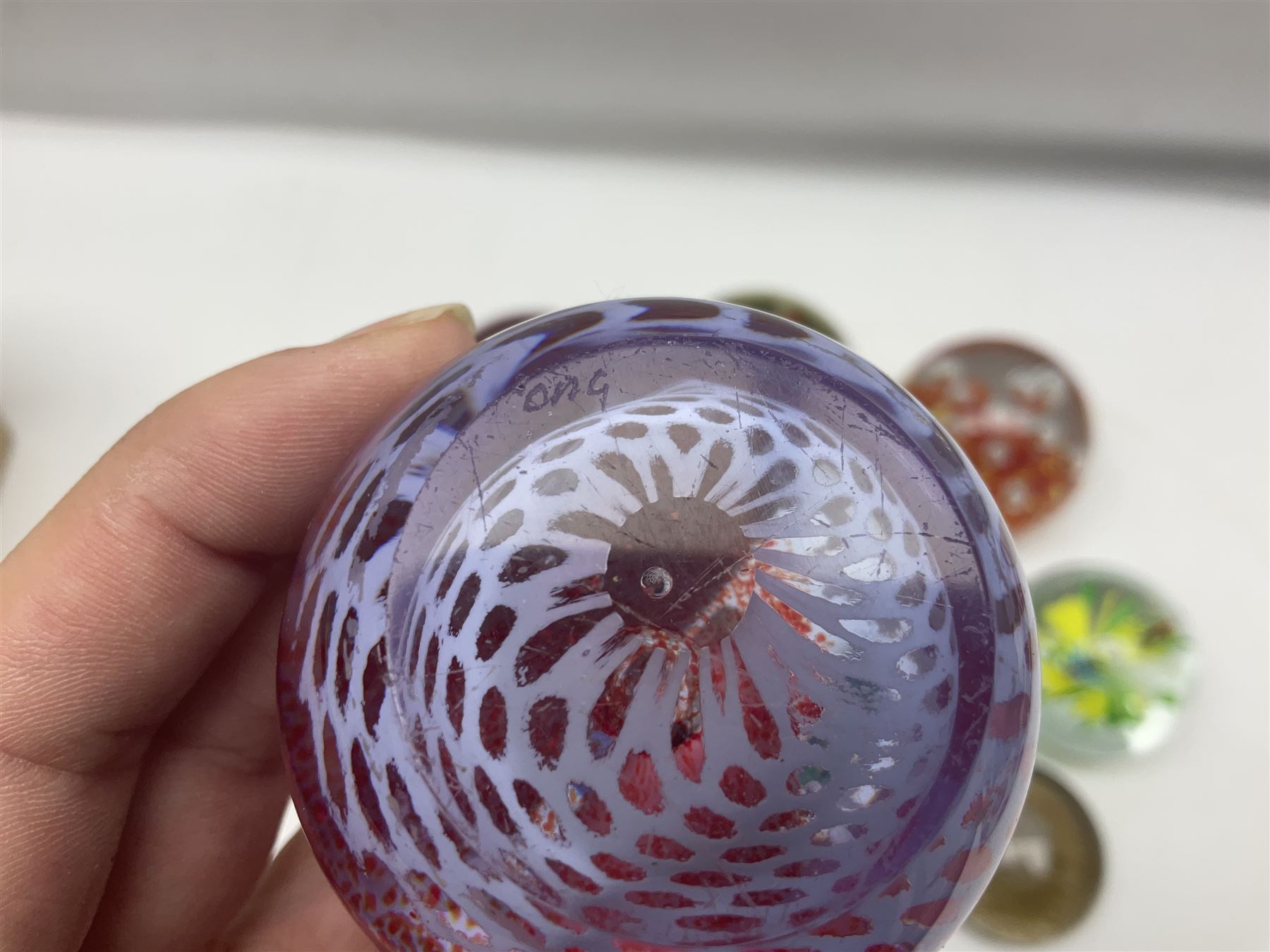 Collection of glass paperweights, to includes examples with internal air bubble inclusions and ones with internal flowers (11)