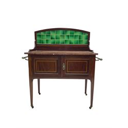 Edwardian inlaid mahogany washstand, raised back with emerald green tiles over marble top, fitted with two panelled cupboard doors, raised on square tapering supports on ceramic castors