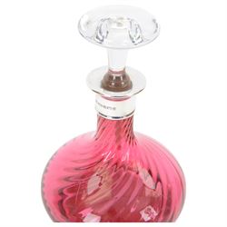 Two modern silver mounted glass decanters, the first a cranberry glass example, with fluted body, clear stopper and silver collar, hallmarked Barker Brothers Silver Ltd, Birmingham 2001, together with a clear cut glass example with silver collar, with import marks for London 1985, tallest H25.5cm