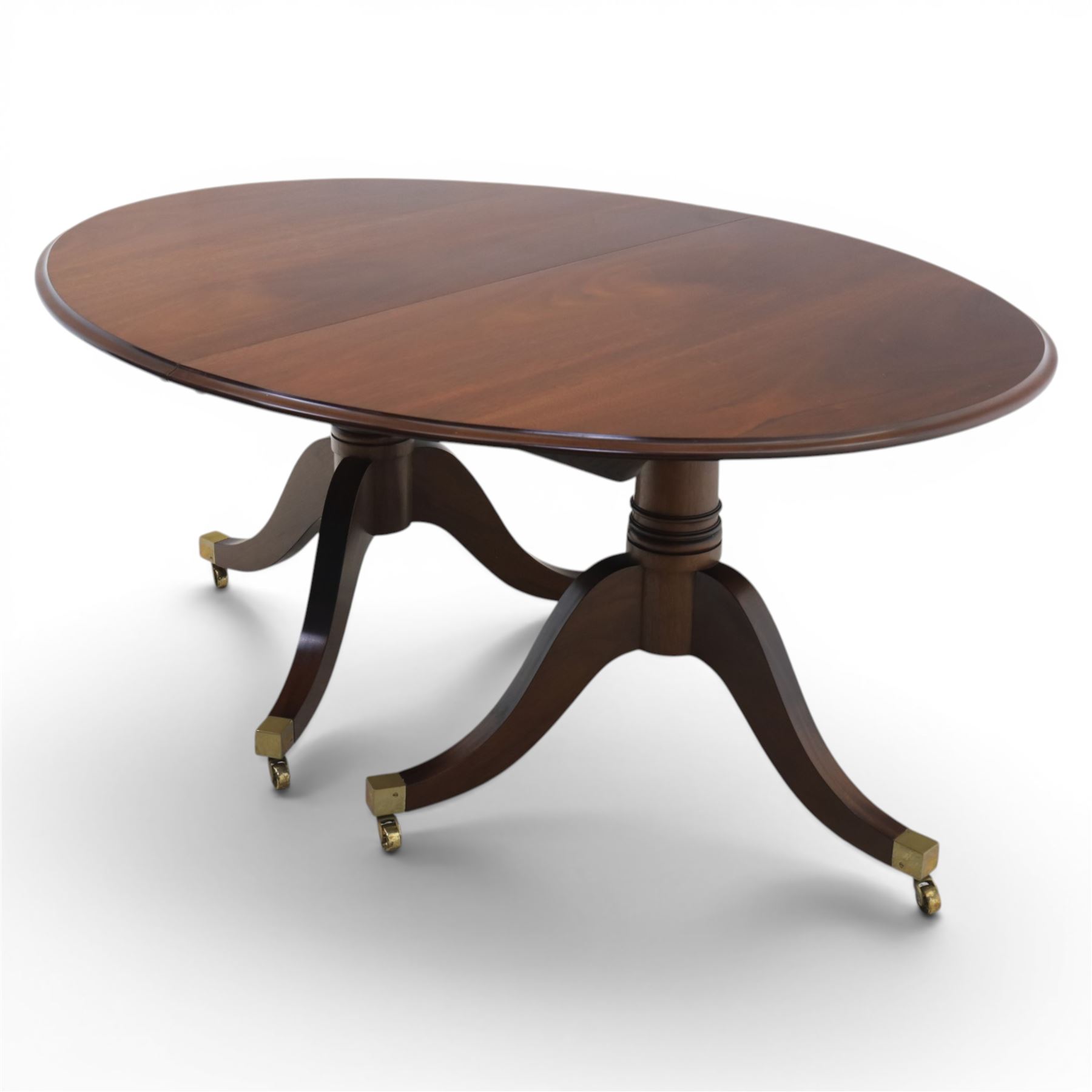 Gott's Pickering - Quality Georgian design rosewood twin pillar extending dining table, with additional leaf, oval form raised on turned columns with tripod legs on cast brass sockets and castors, complete with brass coupling forks, length 164cm without leaf