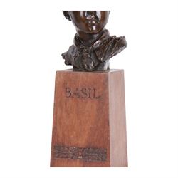 William Goscombe John (Welsh 1860-1952), bronze, bust of Basil Webb as a boy scout, upon a tall oak plinth inscribed BASIL above foliate band, titled to paper label verso and beneath, overall H36cm