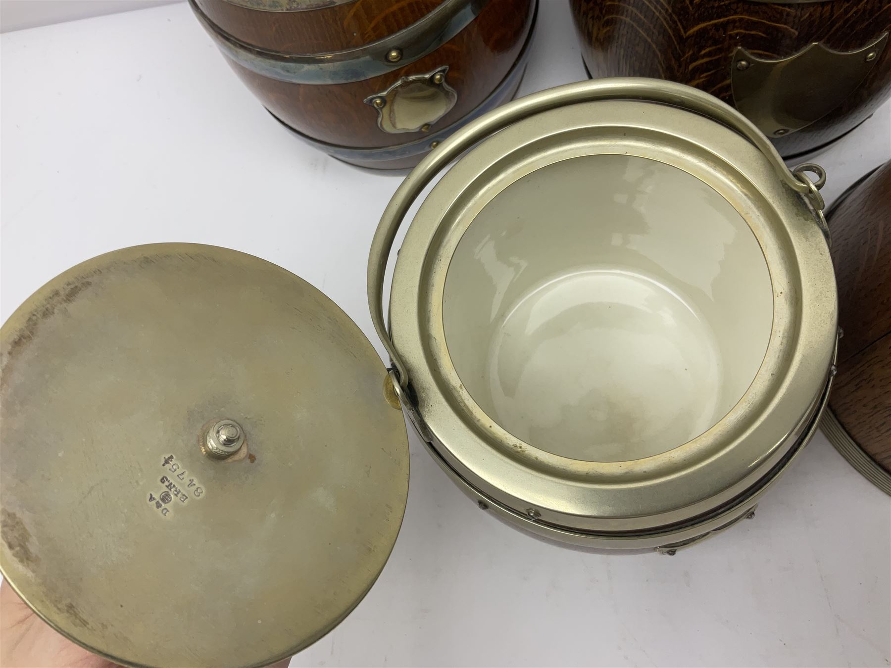 Five early 20th century biscuit barrels with silver-plated mounts