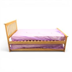 Contemporary light oak trundle bed, slatted headboard and footboard,  incorporating pull-o...