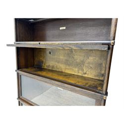 Globe Wernicke - stacking sectional library bookcase, over four glazed up-and-over doors, each bearing original makers mark, on moulded plinth base with inbuilt drawer