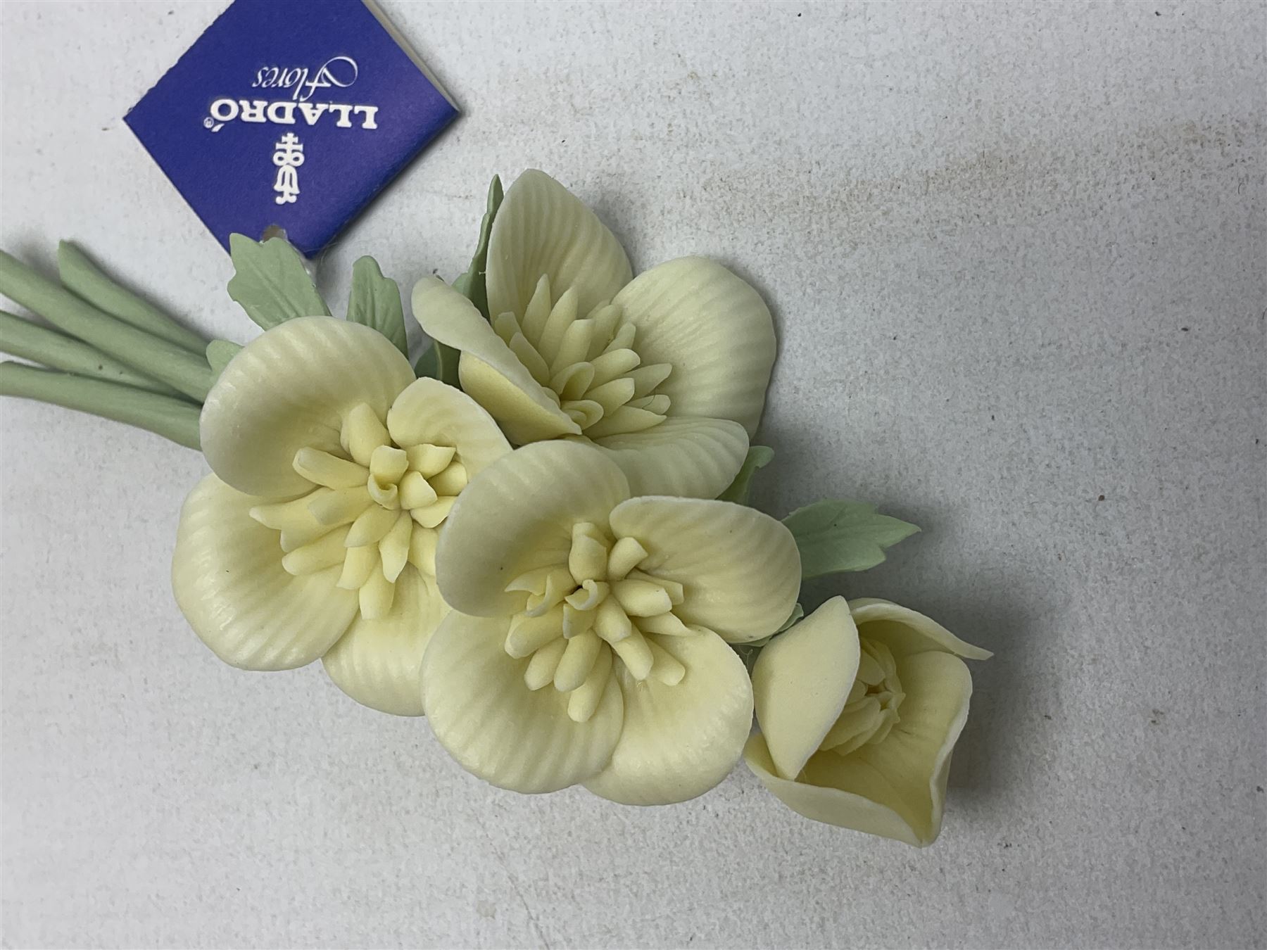 Seven Lladro flowers, comprising Japanese Camelia on base no 5181, Yellow Begonia on base no 5186, Miniature Begonia on base no 5188, Chrysanthemum on base no 5189, California Poppy no 5190.B, Miniature Begonia 5188.B and White Carnation no 5184.B, together with Lladro Spanish Joining pack with 17616 Winter Bell, Additional Lladro parasols and flowers etc 