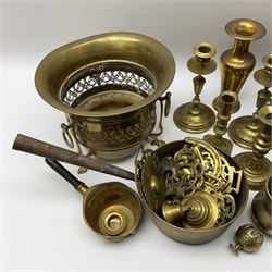 A collection of metal ware, to include a selection of horse brasses, three pairs of brass candle sticks, a set of fire tools, etc. 