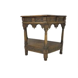 Jacobean design carved oak side or credence table, demi-heptagon top with moulded edge, frieze carved with foliate C-scroll design above ornate arcade carved apron, under-tier united by ring turned pilisters, lower frieze carved with repeating lunettes
