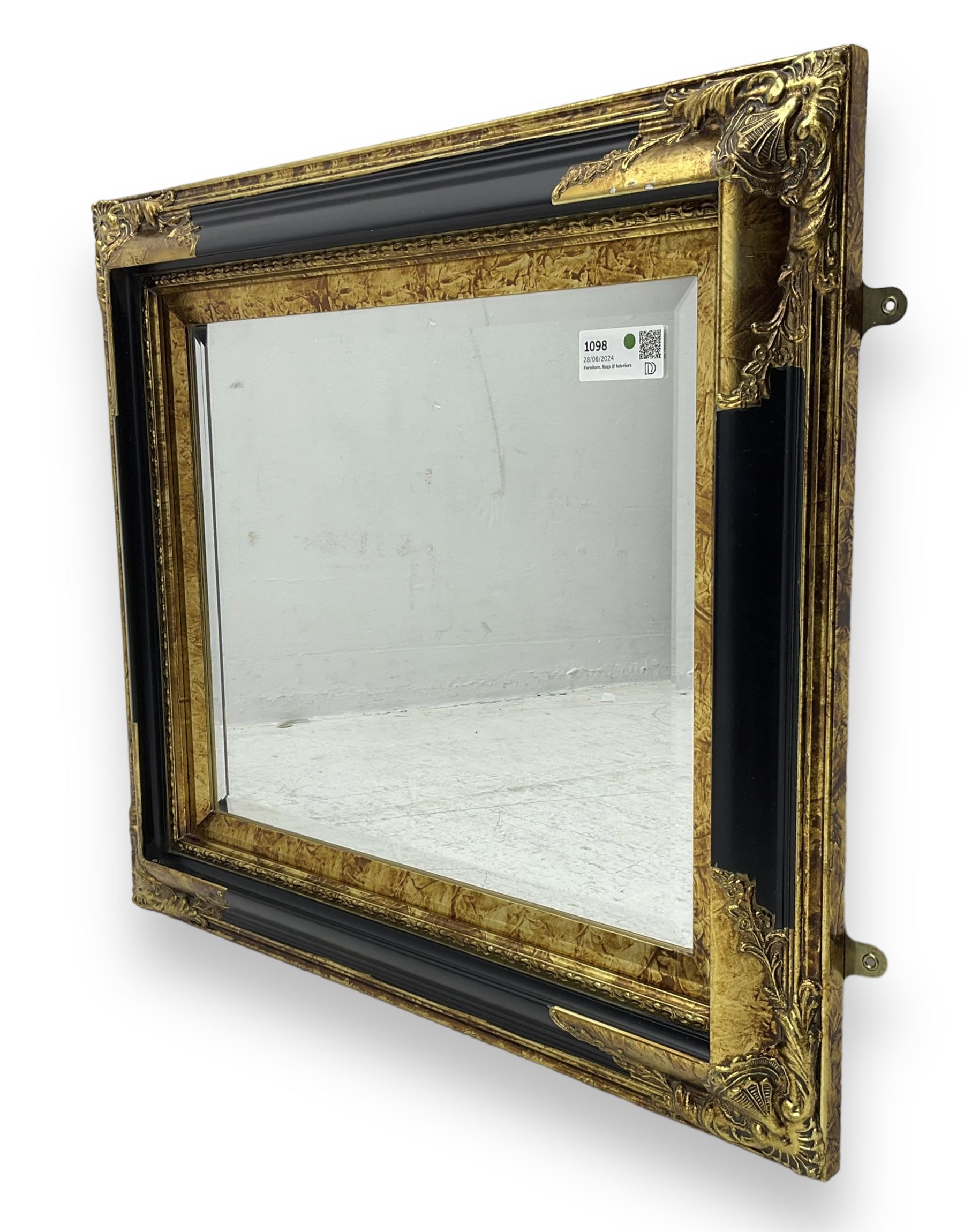 Victorian design ebonised and gilt wall mirror, the moulded rectangular frame decorated with foliate cartouches, bevelled mirror plate 