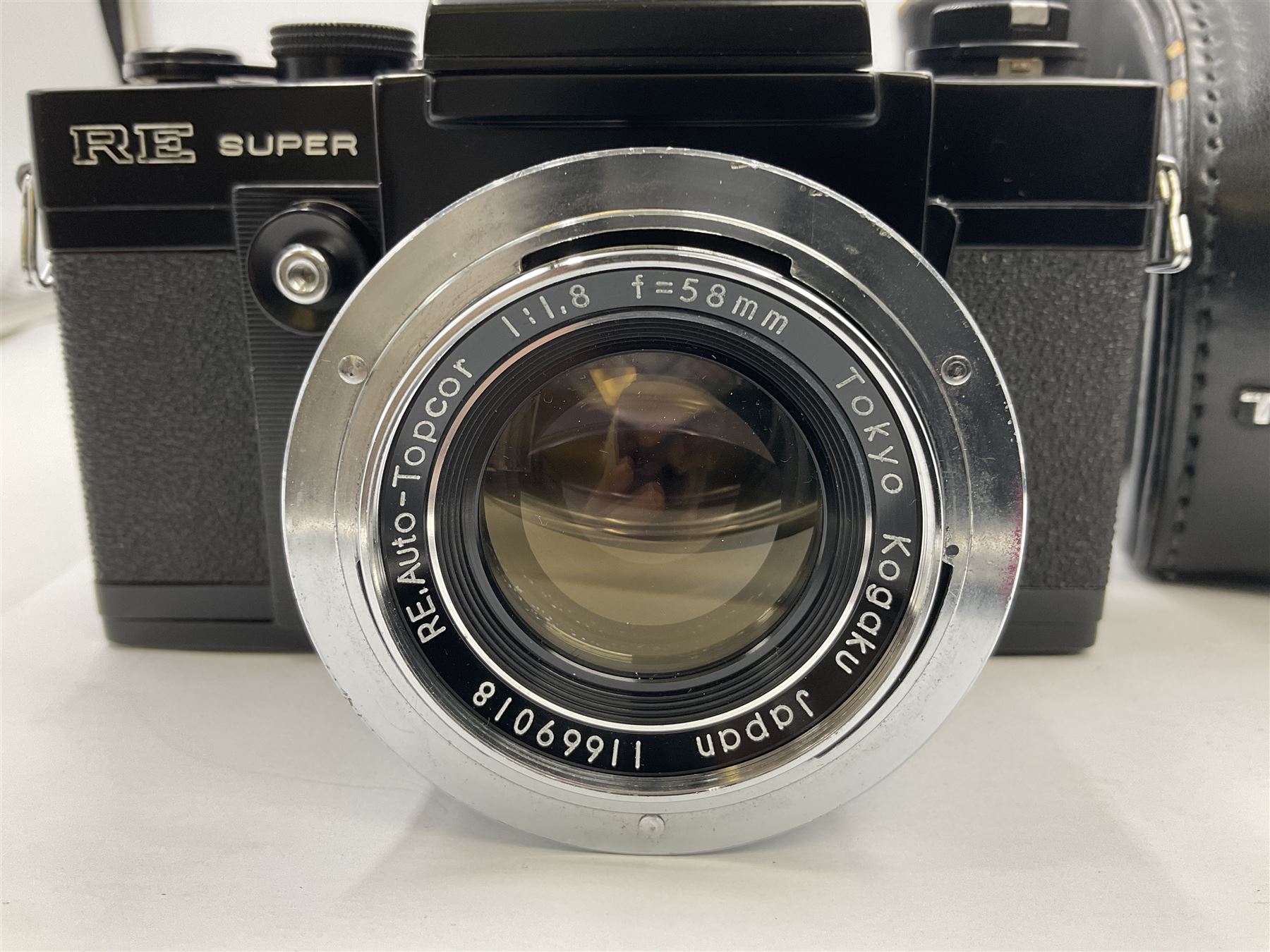 Topcon RE Super camera body, serial no.4681129, with 'RE. Auto-Topcor 1.8/5.8cm' lens, serial no. 11669018, in leather case