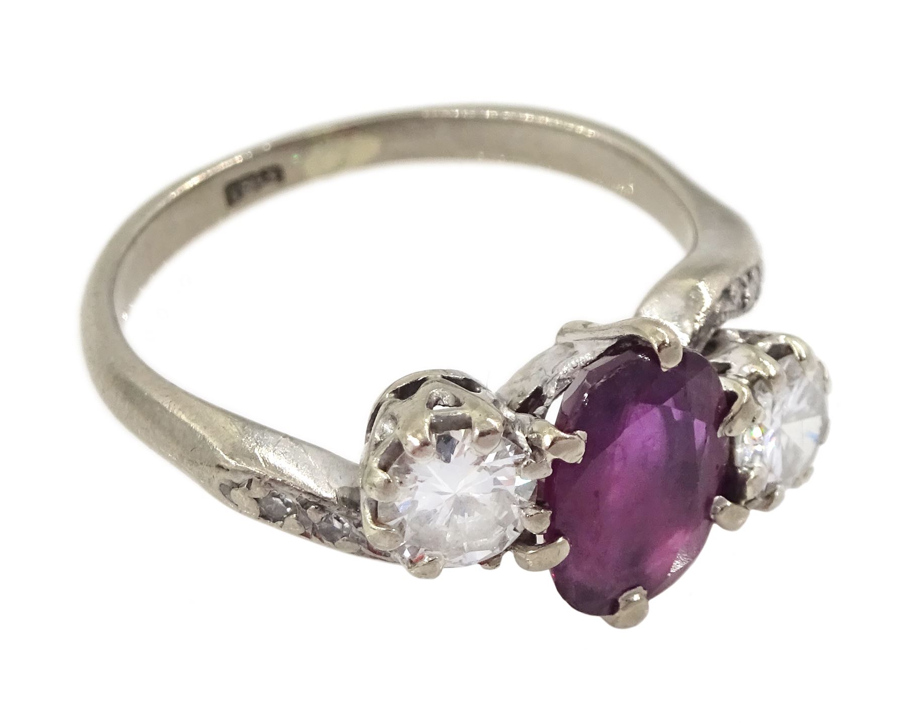 18ct white gold three stone oval ruby and round brilliant cut diamond ring, with diamond set shoulders, stamped, ruby approx 1.15 carat, total diamond weight approx 0.55 carat, in silver top ring box by The Victorian Ring Box Co, Edinburgh 1993 