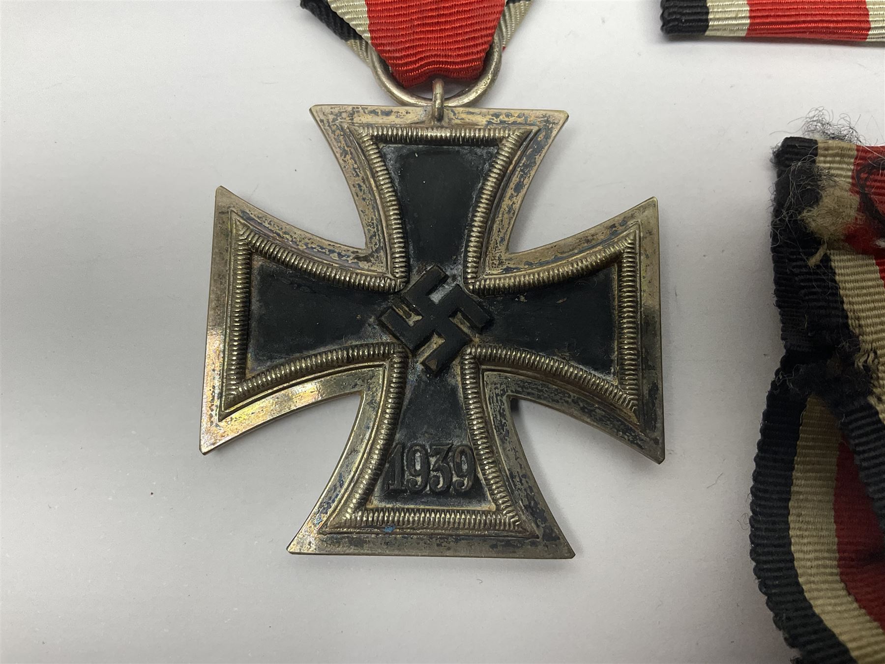 WWII German Iron Cross 2nd Class, the suspension ring stamped 128 for S. Jablonski G.m.b.H. Posen; with ribbon; together with an embroidered cloth eagle badge and quantity of German medal ribbons.