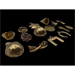 9ct gold charms, including crossed swords, signet ring, horseshoe and leaf, and a 14ct gold fireplace charm