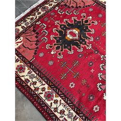 Persian Hamandan rug, the red ground field decorated with triple medallions and stylised motifs