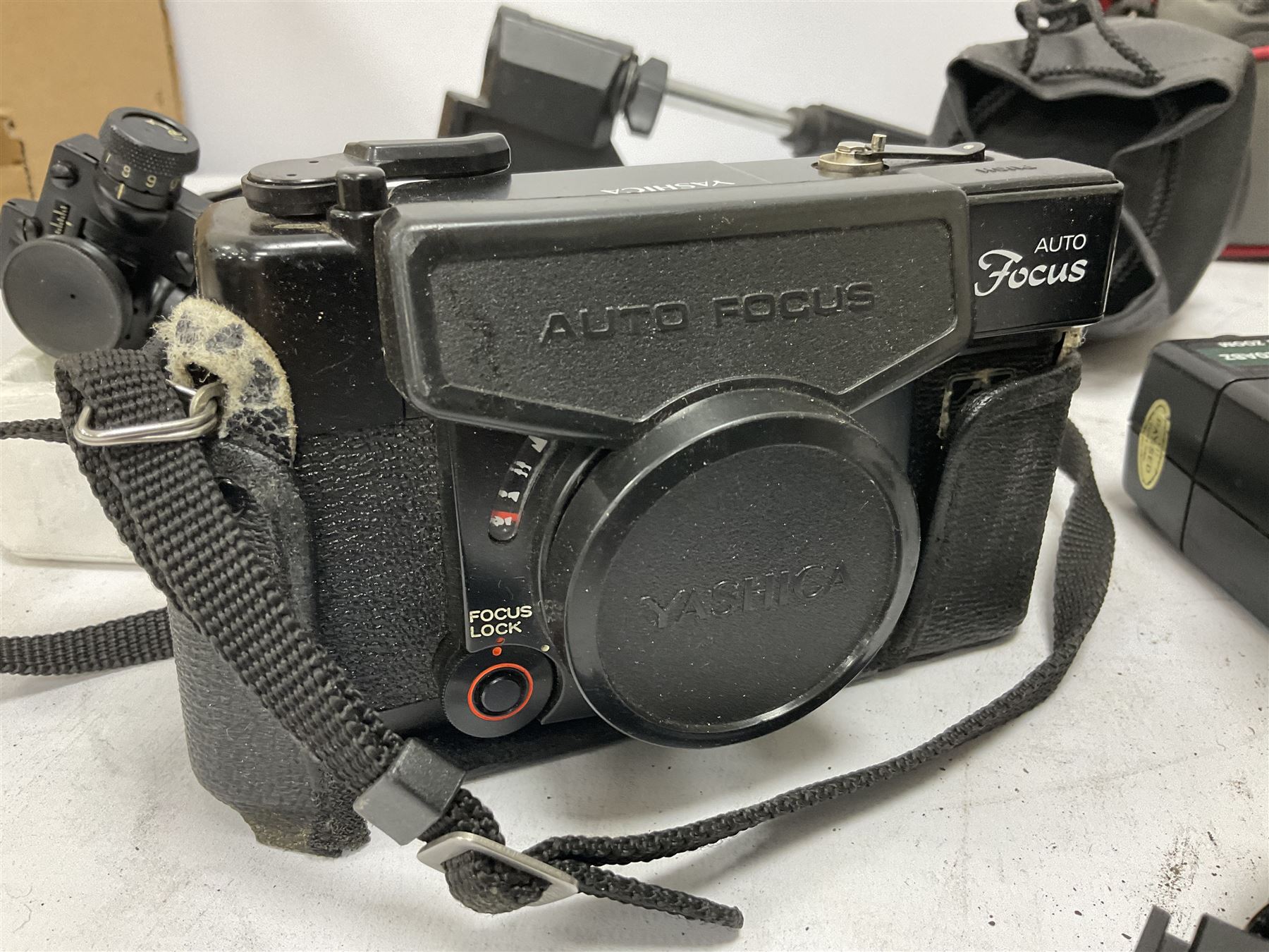 Quantity of cameras and accessories to include Olympus Trip 35, Minolta A f-EII 35mm, Yashica Auto Focus camera, Hanimex 35mm af camera in case, Kodak No.2A Folding Pocket Brownie camera in case, Minolta VLT-501 lens, etc