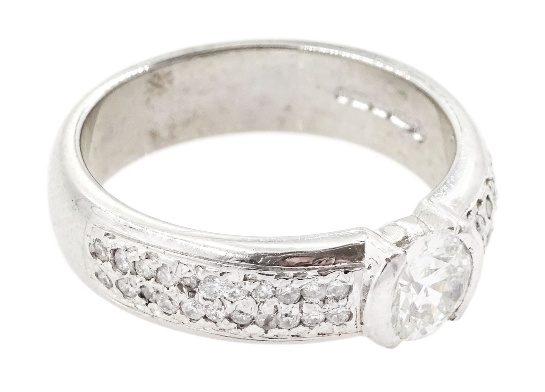 18ct white gold diamond ring, half bezel set with a single round brilliant cut diamond of approx 0.45 carat, with pave set round cut diamond shoulders, hallmarked